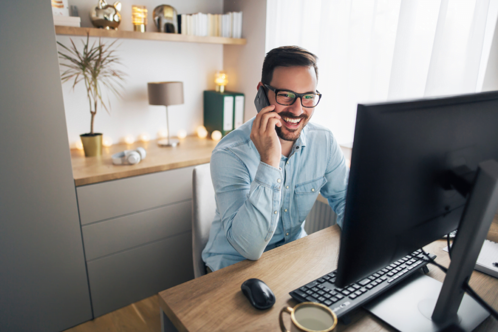 consultant talking on the phone to one of their clients while working in their home office