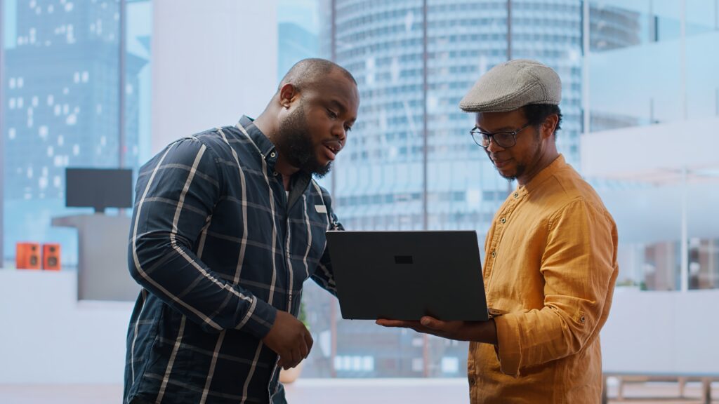 team members looking at a windows laptop